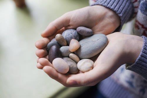 hands with stones