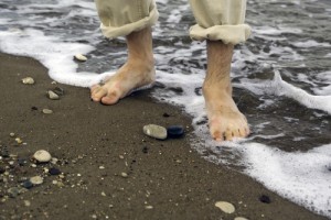 man's feet in water